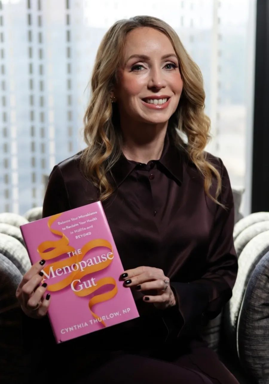 Cynthia Thurlow holding her book The Menopause Gut